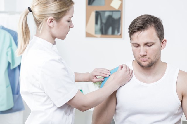 Physiotherapist applying kinesiology tape