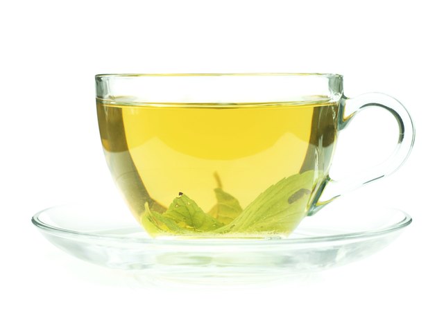 Cup of fresh green tea isollated on white