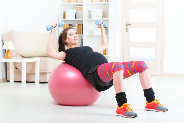 Pregnant woman exercising at home