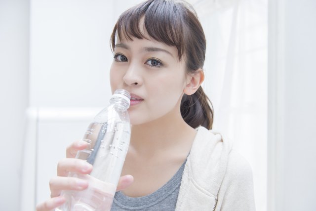 Japanese woman drinking a carbonated water.