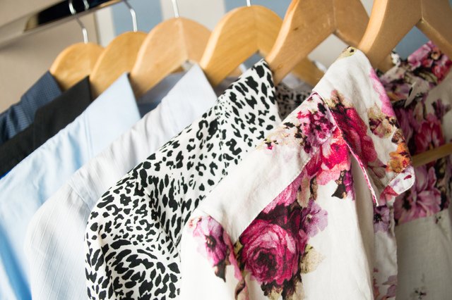 Different clothes on hangers close up
