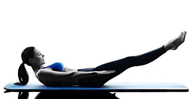 one caucasian woman exercising pilates exercises fitness in silhouette isolated on white backgound