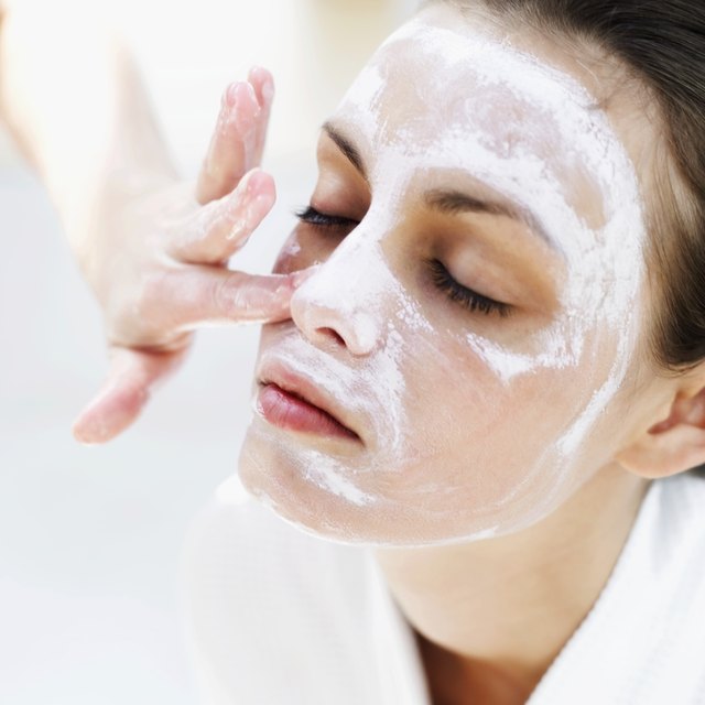 close-up of a woman applying face pack