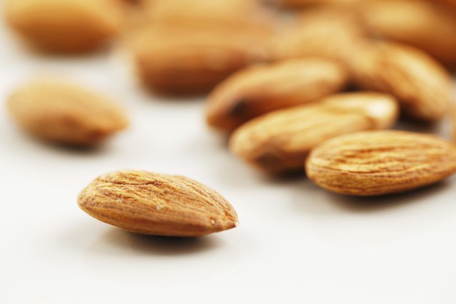 Handful of almonds on a white background