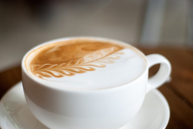 Coffee in white cup on wood table