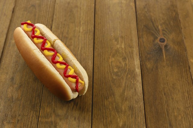 Tasty hot dog on wooden table