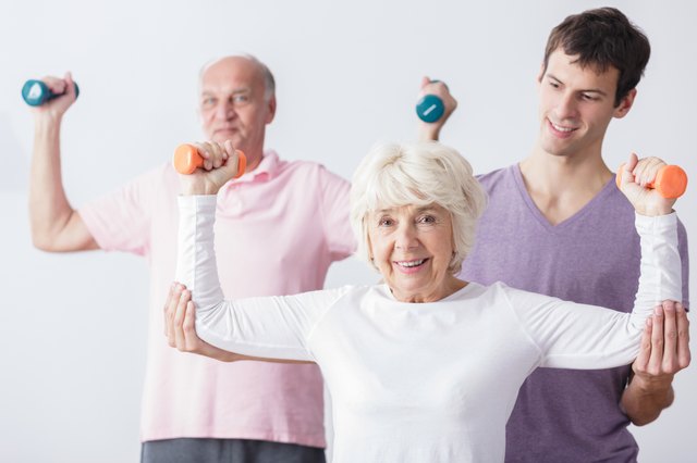 Personal trainer and elderly couple
