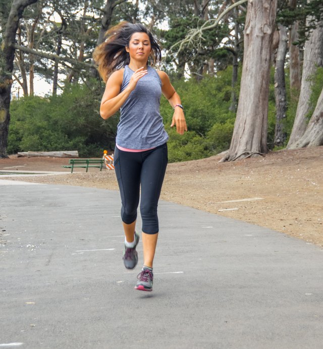 Young woman running on trail