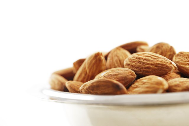 Bowl of almonds on a white background