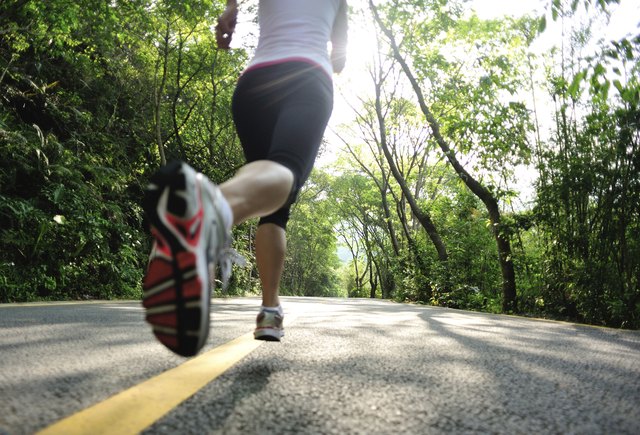 healthy lifestyle fitness sports woman legs running at mountain road