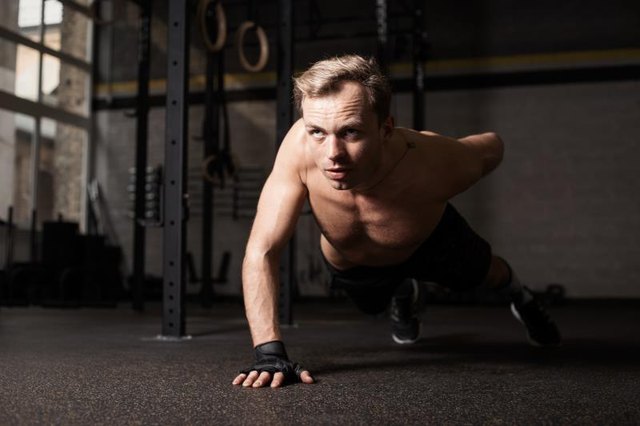 Man doing one hand push-up