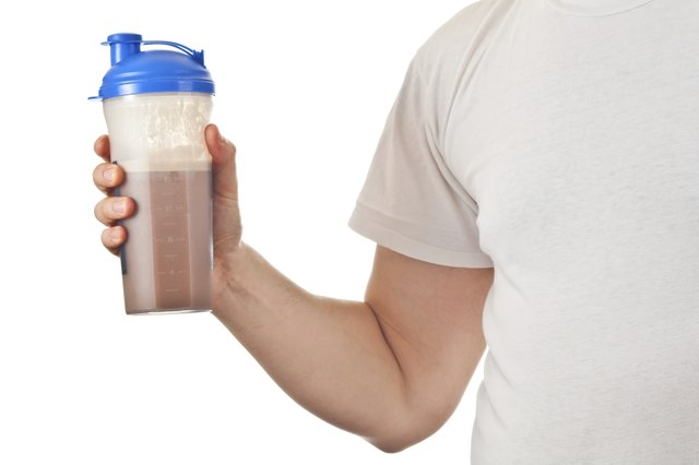 Man holding his post workout chocolate whey protein shake