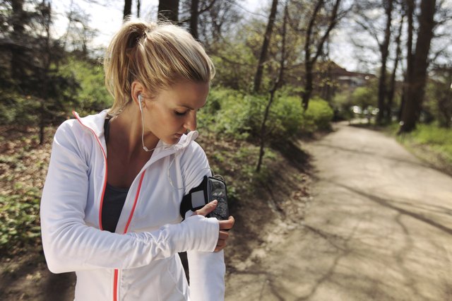 Female runner monitor her progress on smartphone