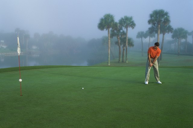 One mid adult man playing golf