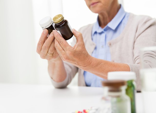 close up of senior woman with medicine jars