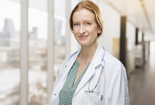 Portrait of female doctor in corridor in hospital.