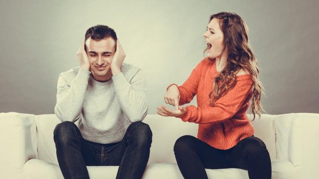 couple having argument - conflict, bad relationships. Angry fury woman screaming man closing his ears.