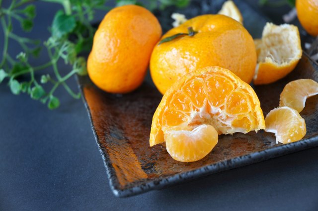 Close up Fresh Orange on Black Plate