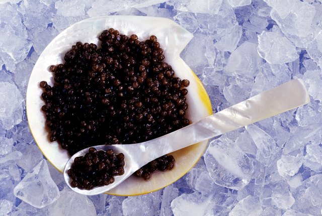 Beluga caviar on mother of pearl plate with spoon
