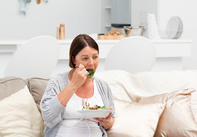 Pregnant woman eating vegetables