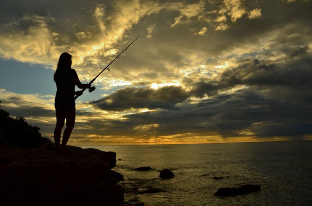 Fishing while standing on a cliff in Hawaii