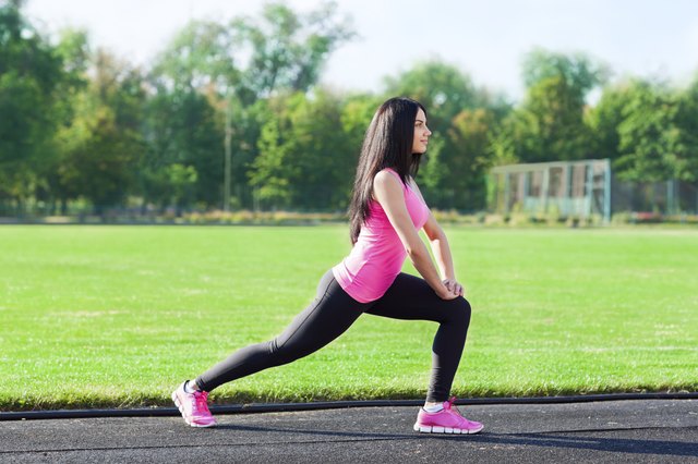 woman sport on stadium leg stretching exercises