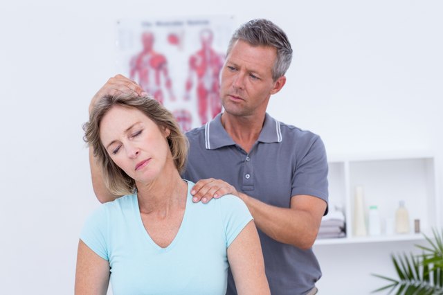Doctor examining his patient neck
