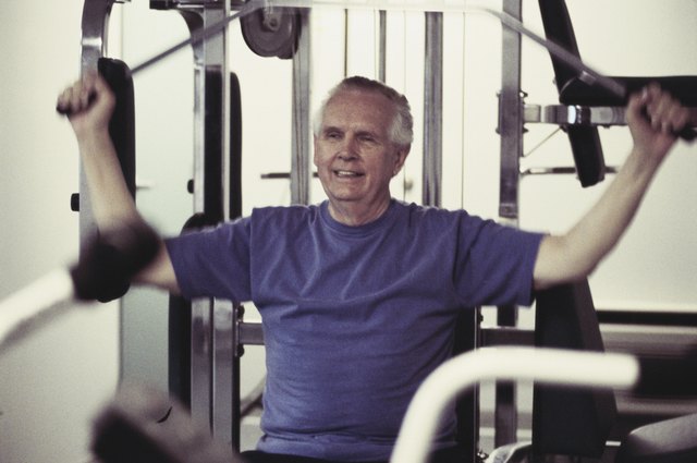 Senior man exercising on a machine