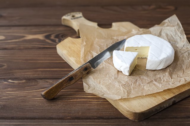 piece of Camembert with knife