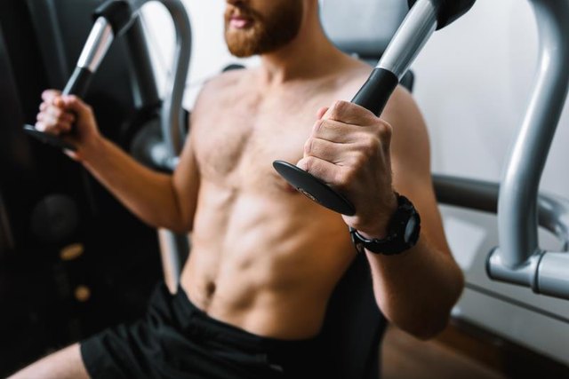 Focus on strong hands holding part of power training apparatus