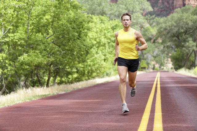 Runner man running on road