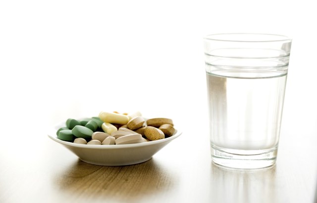 vitamin pills and a glass of water