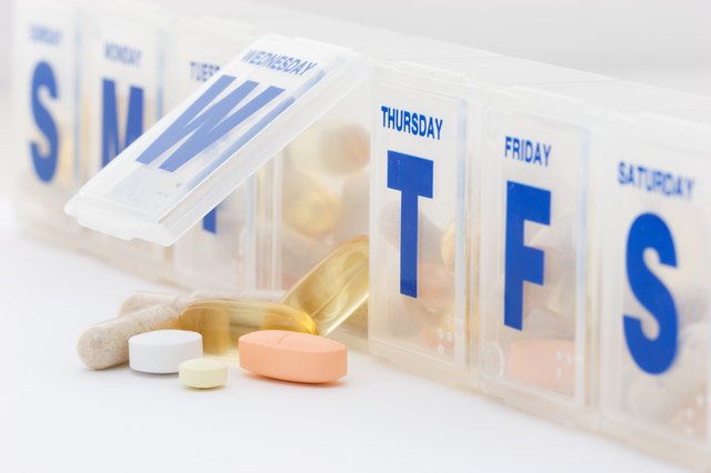 Daily vitamin and supplement pills with organizer