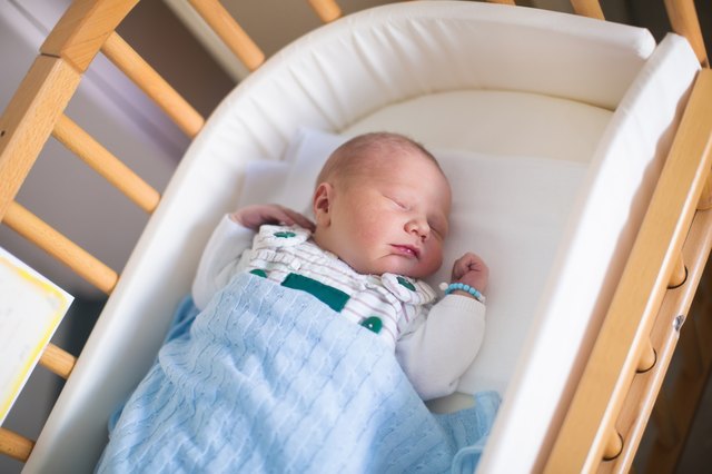 Newborn baby boy in hosptal cot