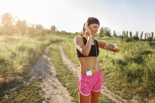 young girl goes in for sports with gadget at hand