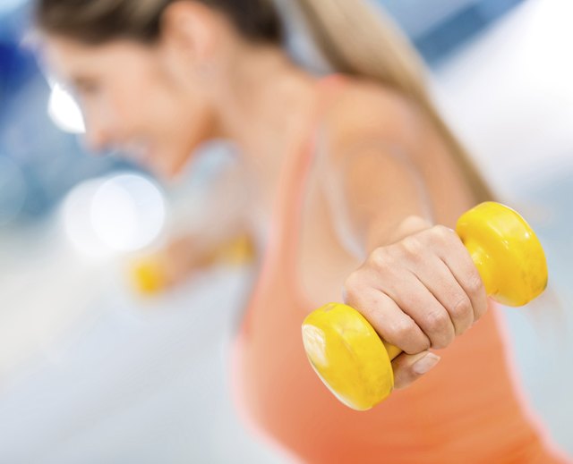 Gym woman lifting weights