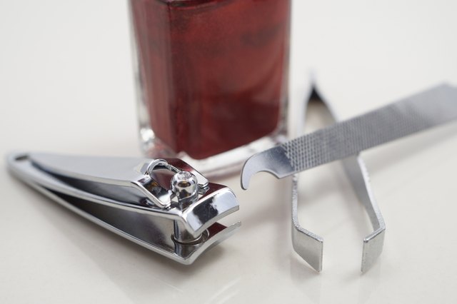 Nail clipper, file, nail polish and tweezer