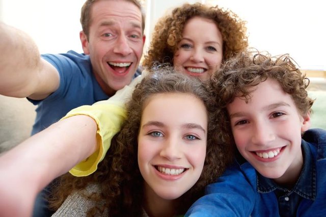 Happy family with teenage children.