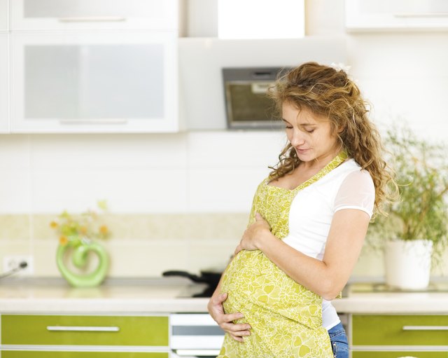 pregnant woman at home in kitchen