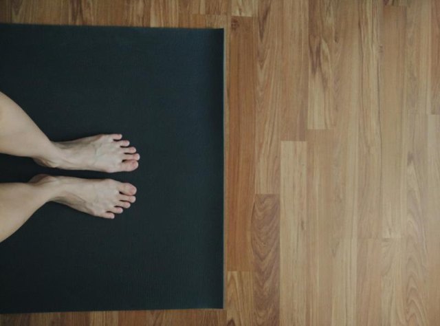 Feet on yoga mat, doing yoga at home, taken with mobile phone