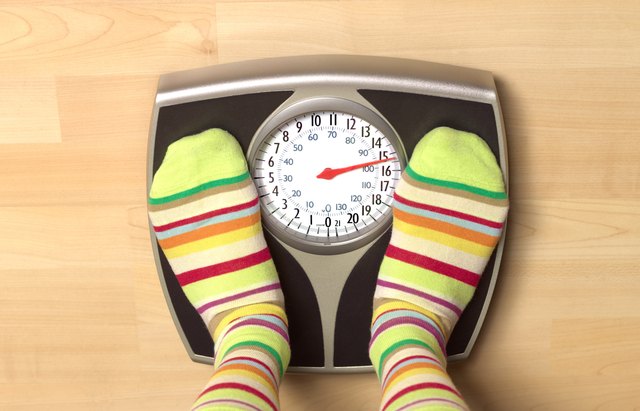 Overweight woman on bathroom scales