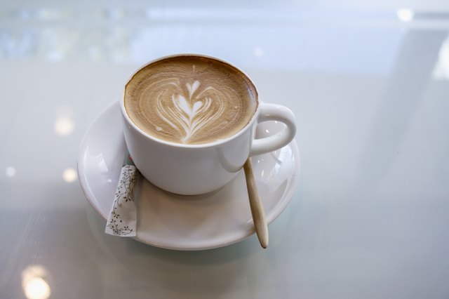 cup of hot latte art heart shape for morning