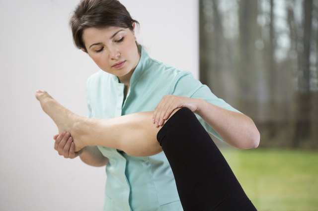 Physiotherapist flexing knee