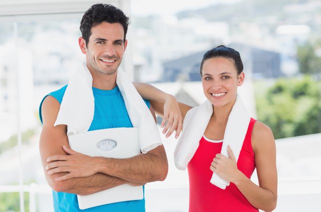 Portrait of a fit couple in bright exercise room