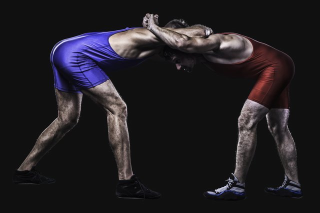 Two wrestlers holding each other in clutch isolated