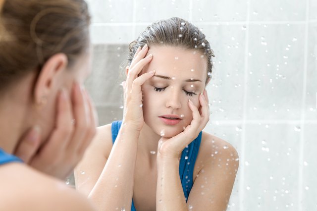 Young woman washing her face