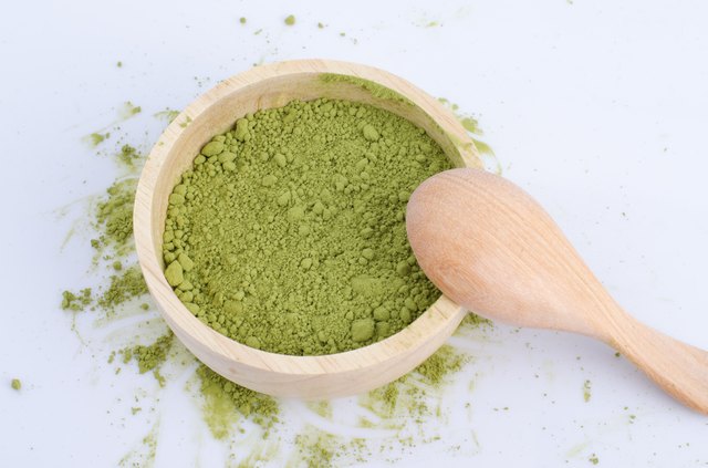 green powder heap isolated on white background