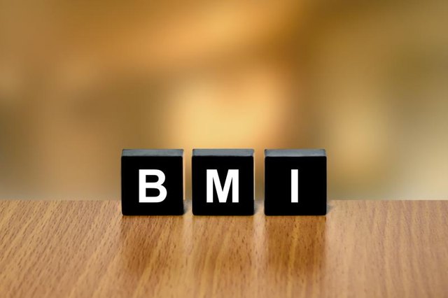 BMI or Body Mass Index on black block with blurred background