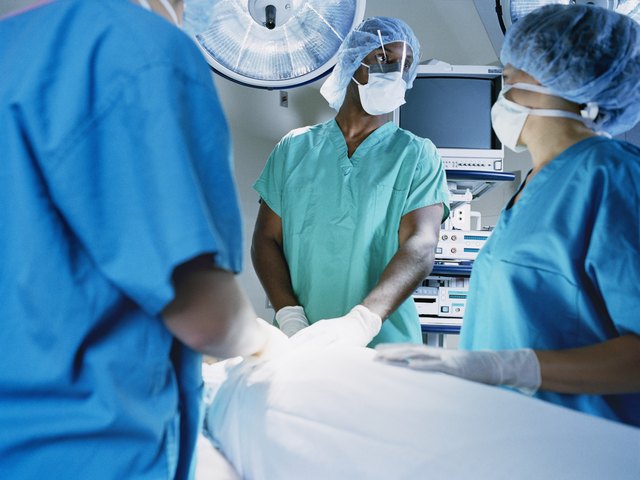 Medical professionals operating on a patient in an operation theater