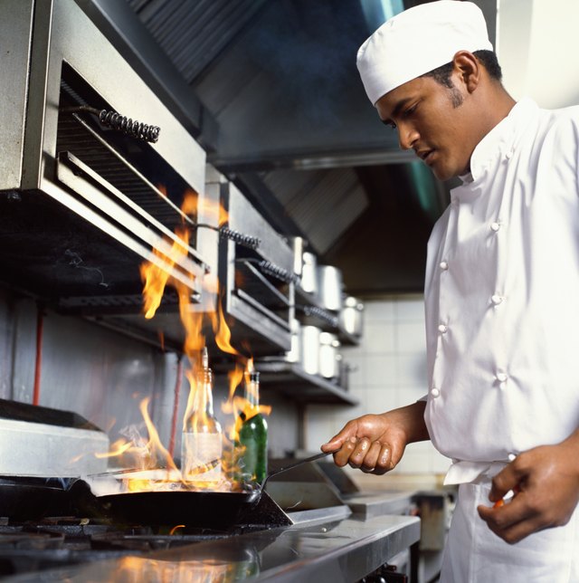 side profile of a chef cooking food in the kitchen